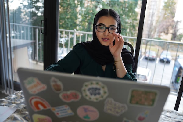 Marjila Badakhsh, who was laid off from her position with the Lutheran Social Services National Capital Area resettlement program after the Trump administration upended the federal refugee program, works on her computer in Alexandria, Va., Wednesday, March 5, 2025. (AP Photo/Jessie Wardarski)