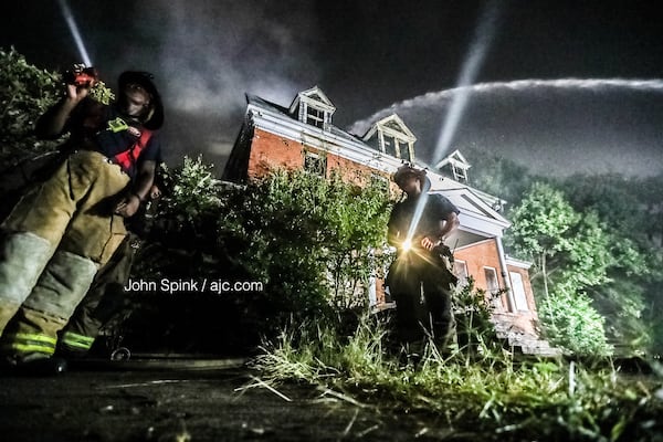 Atlanta firefighters continue to put out hot spots on the scene of a large fire near Morris Brown College on Thursday morning. Flames could be seen for miles as the fire raged Wednesday night. 