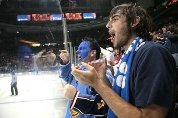 Conrad Bromberek of Newnan (left) and Mike Gaughan of Atlanta cheer as the Thrashers.