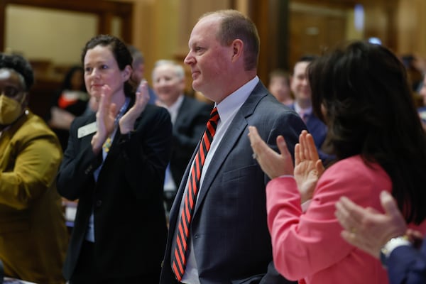 Members of the House of Representatives welcome Rep. Holt Persinger, R-Winder, on his first day of the legislative session on March 6, 2023. Persinger is the sponsor of House Bill 268, a hefty piece of legislation that seeks to keep schools safe, in part, by sharing some students’ behavioral health information. (Natrice Miller/AJC)