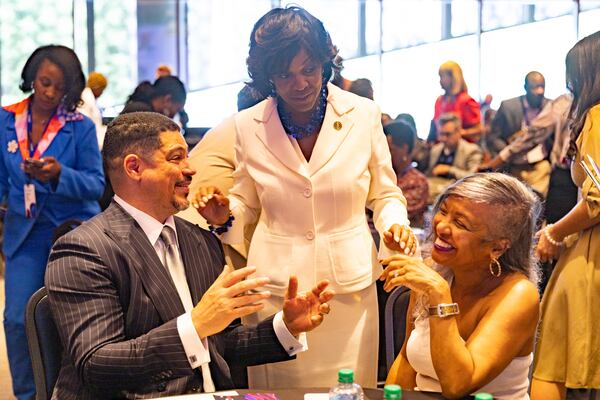 Valerie Montgomery Rice, president and CEO of Morehouse School of Medicine, speaks to Jon (left) and Donna Croel (right), founders of the Croel Family Foundation, during the inaugural Dr. David Satcher Global Health Equity Summit in Atlanta on Thursday, September 14, 2023. (Arvin Temkar / arvin.temkar@ajc.com)