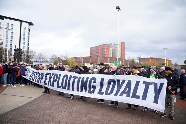 Fans hold a banner prior to the start of the English Premier League soccer match between Manchester United and Everton at the Old Trafford stadium in Manchester, England, Sunday, Dec. 1, 2024. (AP Photo/Dave Thompson)