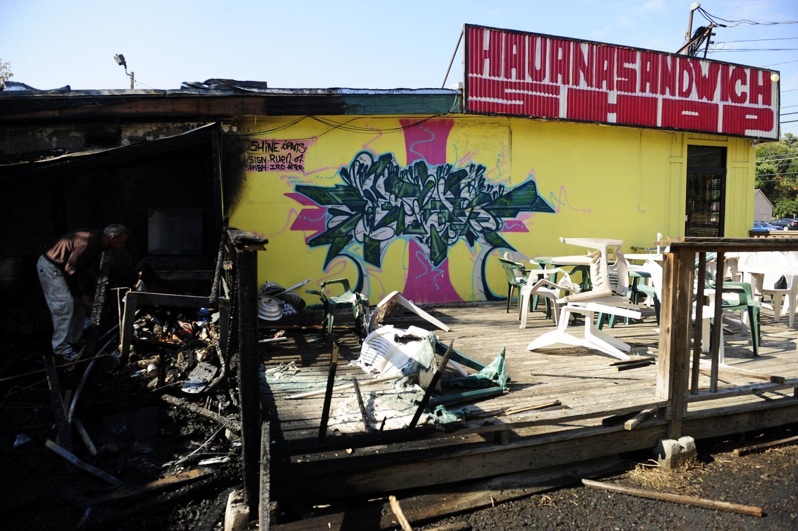 Marcel Louis DeMaria, who says he is a regular customer of Havana Sandwich Shop on Buford Highway, looks through the damaged left by an early morning fire Monday, Oct 7, 2008. Several times in the last 32 years, this restaurant has been recognized by the national guide Zagat as being the “Top Cuban Restaurant in Atlanta.” Elissa Eubanks/AJC