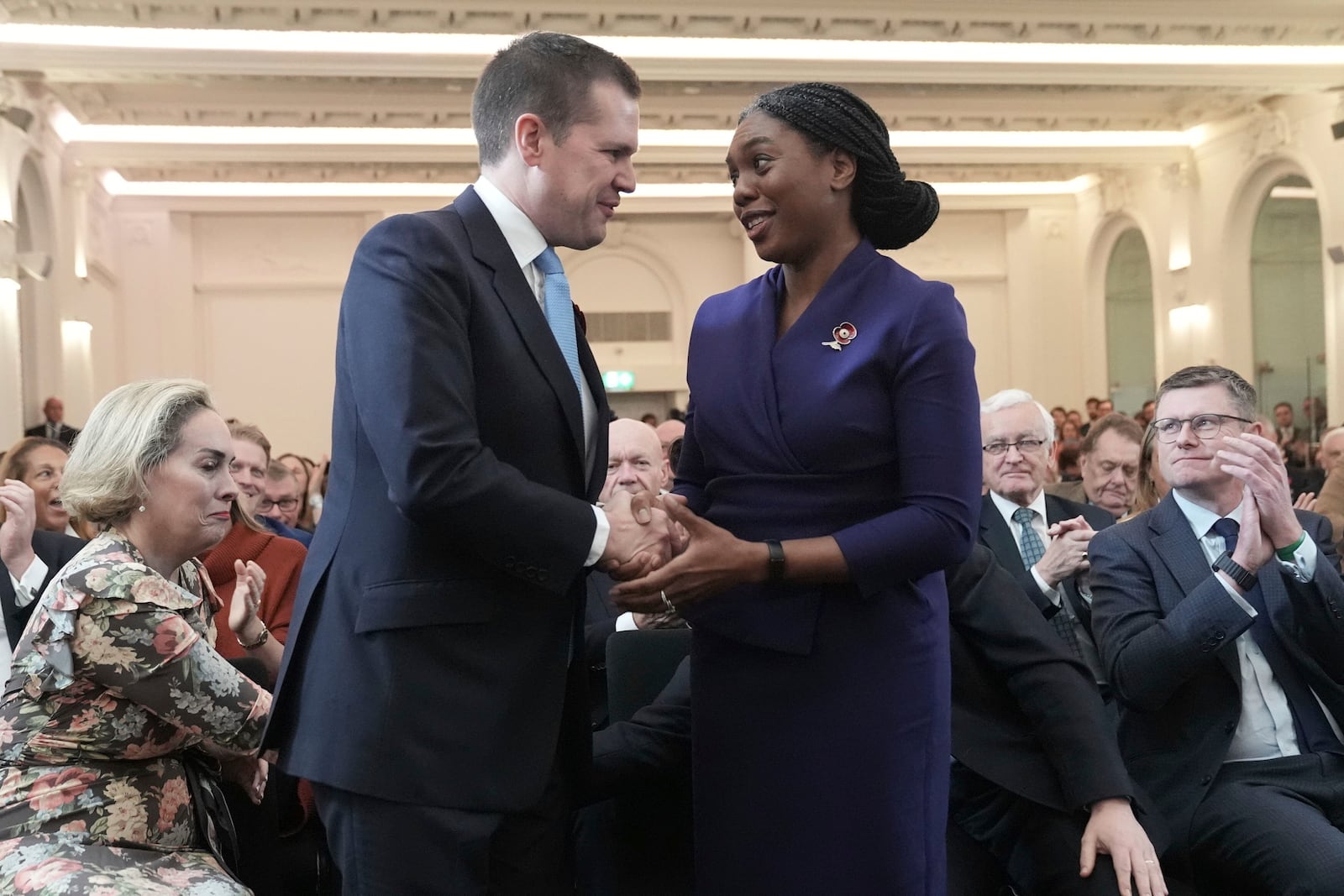 Britain's Member of Parliament Kemi Badenoch is congratulated by Robert Jenrick after being announced as the new Conservative Party leader following the vote by party members, at 8 Northumberland Avenue in central London, Saturday Nov. 2, 2024. (Stefan Rousseau/PA via AP)