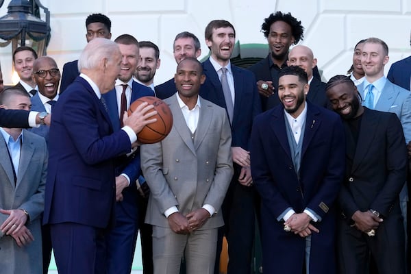 Boston Celtics players react as President Joe Biden holds the ball they presented to him during an event to celebrate the Celtics victory in the 2024 National Basketball Association Championship, on the South Lawn of the White House in Washington, Thursday, Nov. 21, 2024.