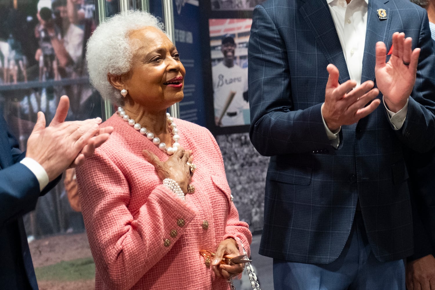 Billye Aaron takes in the applause after cutting cutting the ribbon to open the Atlanta History Center exhibit "More Than Brave: The Life of Henry Aaron" on Monday, April 8, 2024. (Ben Gray / Ben@BenGray.com)