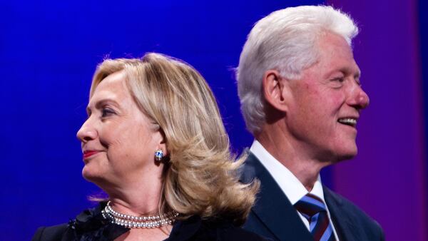 Former US President Bill Clinton (R) stands on stage with his wife Hillary Rodham Clinton, Secretary of State during the closing Plenary session of the seventh Annual Meeting of the Clinton Global Initiative (CGI) at the Sheraton New York Hotel on September 22, 2011 in New York City. (Photo by Daniel Berehulak/Getty Images)