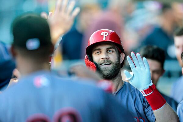 Bryce Harper celebrates after hitting a solo homer against the Gwinnett Stripers in the first inning while he begins his rebab assignment at Lehigh Valley Iron Pigs in Allentown, Pa., Tuesday, Aug. 23, 2022. (Steven M. Falk/The Philadelphia Inquirer via AP)