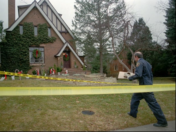 A Boulder police detective walks to the home of John and Patsy Ramsey in Boulder, Colorado, on Jan. 3, 1997, as investigators sifted through evidence in the home where JonBenet was found dead. 