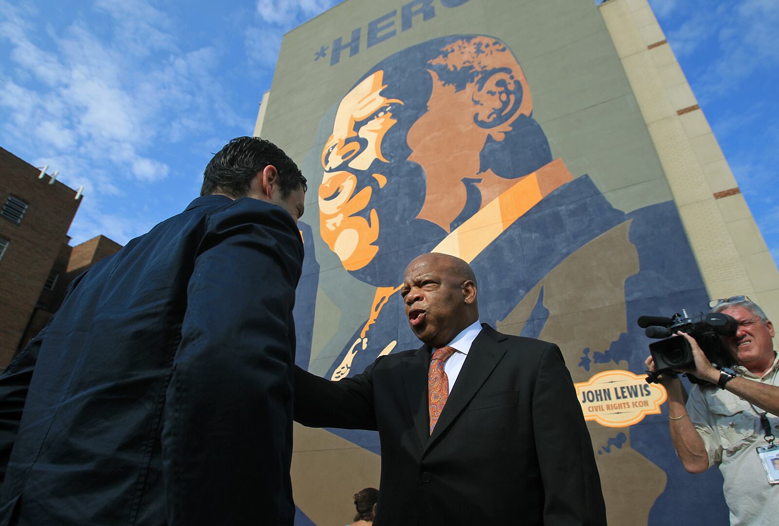 John Lewis was honored with the 2012 dedication of the colossal "HERO" mural in downtown Atlanta. The 65-foot tall painting by Sean Schwab, at the corner of Jesse Hill Jr. Drive and Auburn Avenue, made Lewis' face part of the city's skyline. (Jason Getz / AJC file)