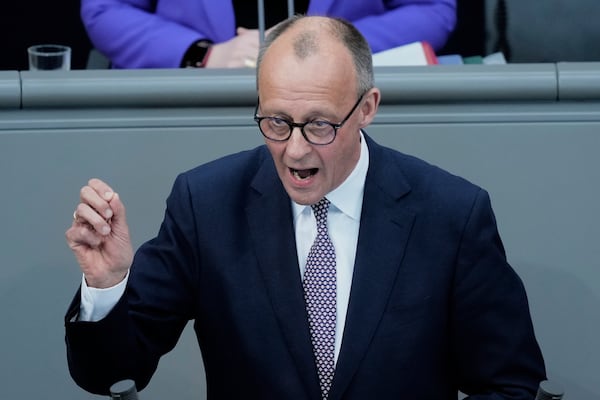 German opposition leader and Christian Democratic Union party chairman Friedrich Merz, right, speaks during a debate and voting about loosen the country's debt rules and change constitution in the German Parliament Bundestag in Berlin, Germany, Tuesday, March 18, 2025. (AP Photo/Ebrahim Noroozi)