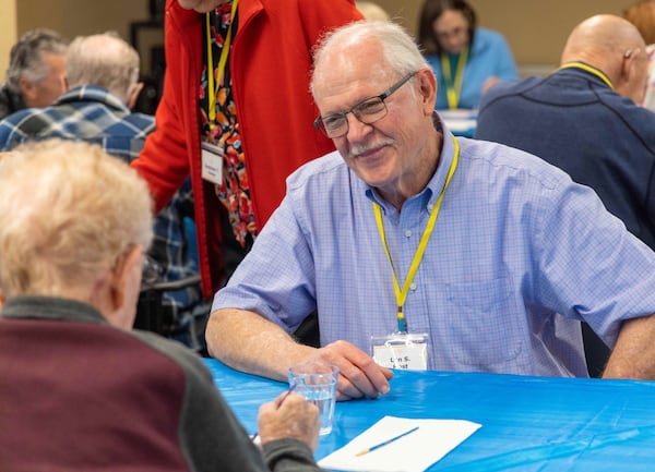 Volunteer Len Sinclair helps a member work on art project together during a Respite Care Atlanta meeting at Second-Ponce de Leon Baptist Church in Atlanta. 
PHIL SKINNER FOR THE ATLANTA JOURNAL-CONSTITUTION