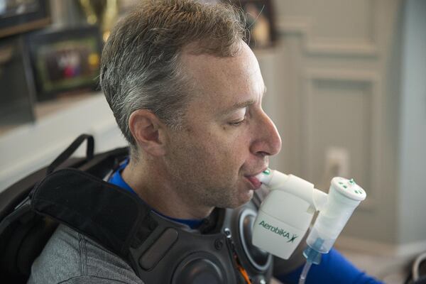 Andy Lipman takes his afternoon medication and undergoes therapy treatment at his home in Sandy Springs. This machine helps clear the mucus from his lungs. ALYSSA POINTER / ALYSSA.POINTER@AJC.COM