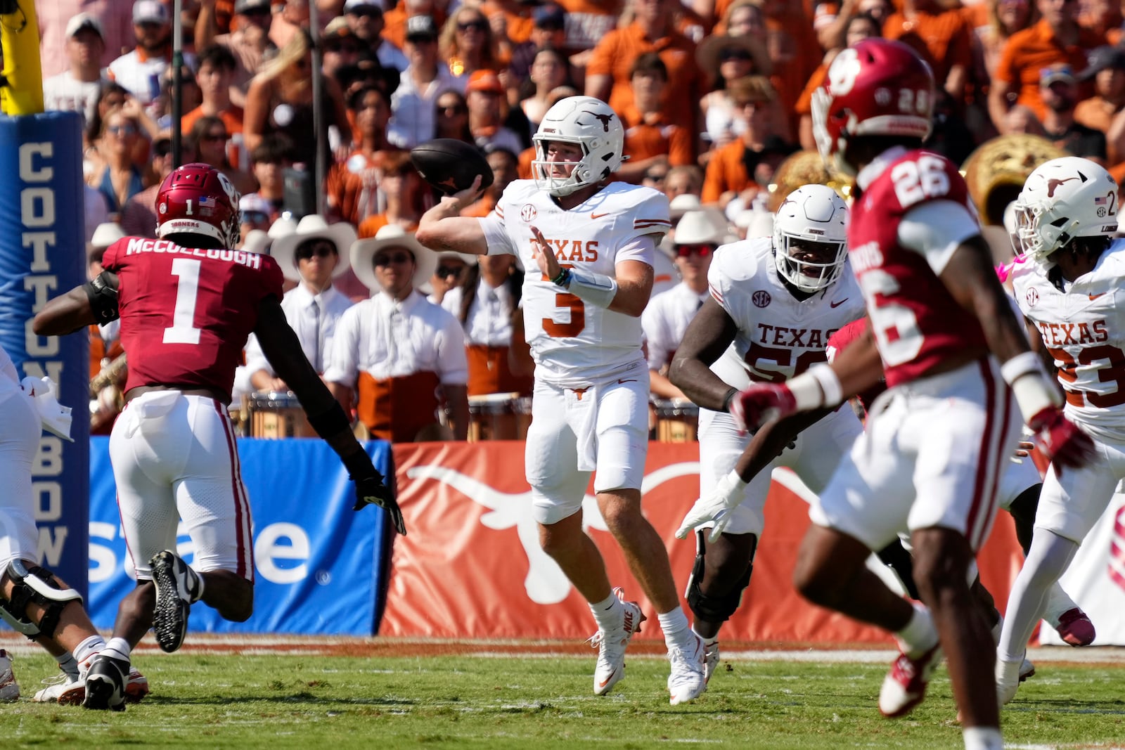 Texas quarterback Quinn Ewers (3) throws from the pocket as Oklahoma linebacker Dasan McCullough (1) rushes in the first half of an NCAA college football game in Dallas, Saturday, Oct. 12, 2024. (AP Photo/Jeffrey McWhorter)