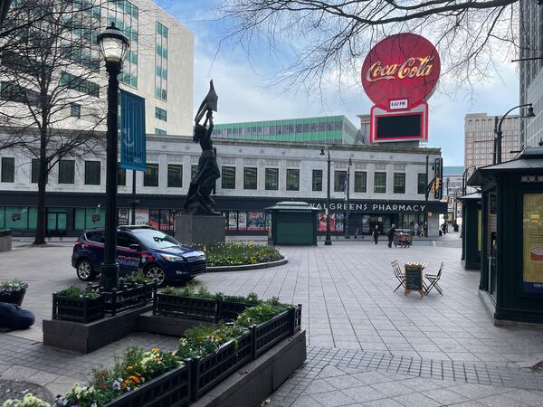 The Walgreens set to be closed in April, as seen from the renovated Woodruff Park where a police car now routinely stands guard.