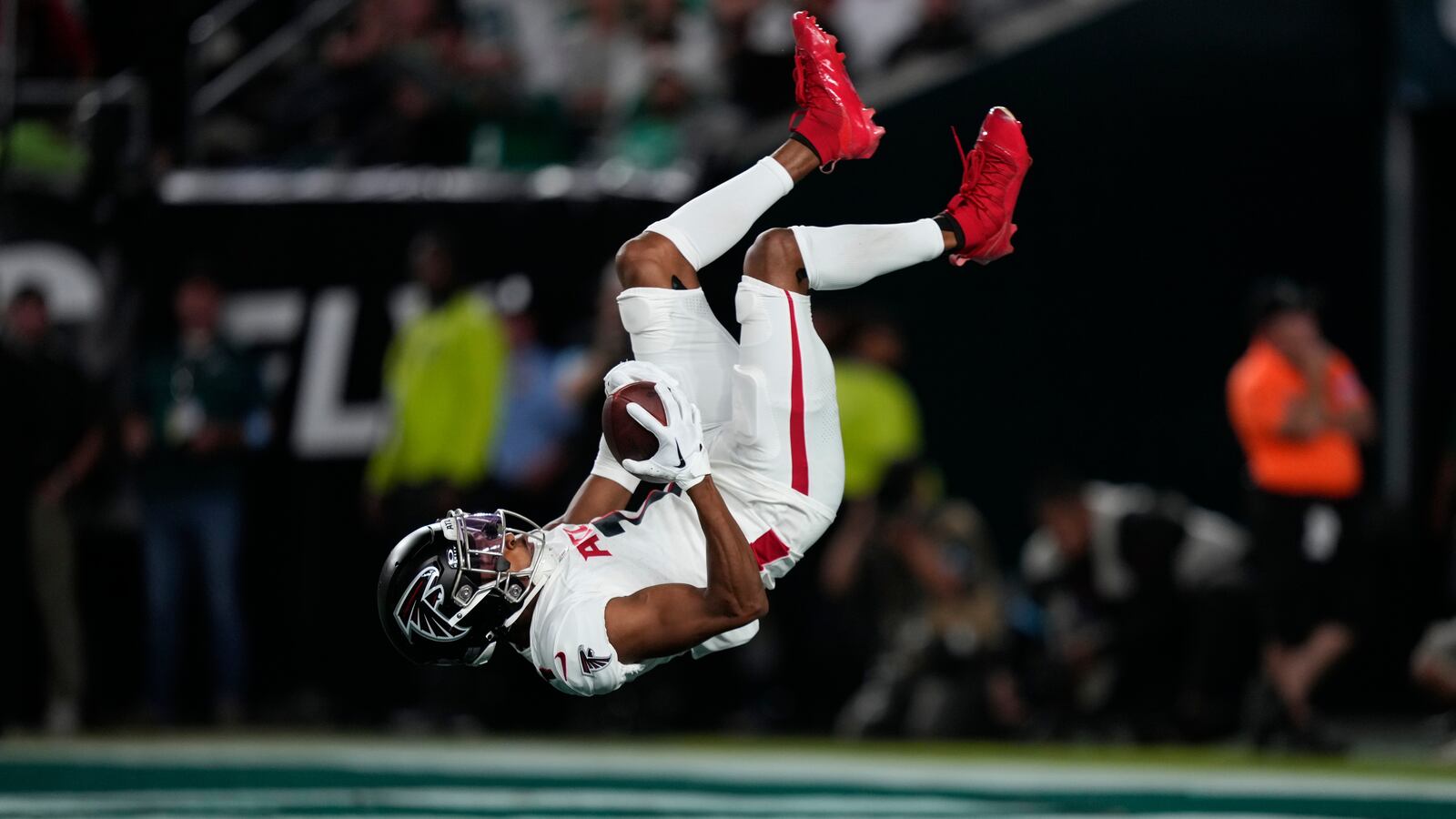 Falcons receiver Darnell Mooney flips into the end zone for a touchdown against the Eagles. 