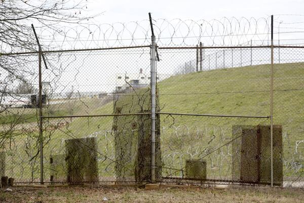 February 21, 2017, Atlanta — Patches of metal are bolted to the fence along the United States Penitentiary in Atlanta to cover holes used by the minimum-security inmates to smuggle contraband into the camps. (DAVID BARNES / SPECIAL)