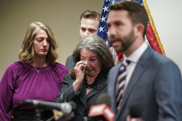 Virginia Baker, mother of slain UGA law student Tara Louise Baker, wipes tears from her eyes as Georgia state Rep. Houston Gaines speaks during a news conference this month about an arrest in the 23-year-old cold case death.