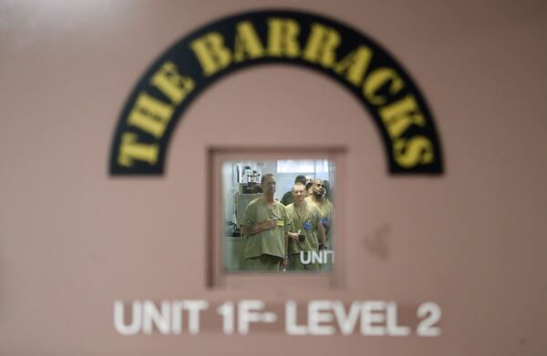 November 20, 2019 - Lawrenceville - The door to the unit bears “The Barracks” logo. Inmates are lined up to receive their medication. The Gwinnett County jail has designated a new housing unit just for inmates who are military veterans. “The Barracks” is intended to be a therapeutic, 70-bed unit focused on providing the type of support crucial to helping incarcerated veterans make a successful transition back into the community. Bob Andres / robert.andres@ajc.com