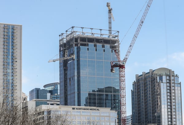 The 1105 West Peachtree development includes luxury condos, a hotel and a 410-foot office building for Google and a large law firm. Construction was delayed when a crane toppled over but the project is expected to open this year. (John Spink / John.Spink@ajc.com)