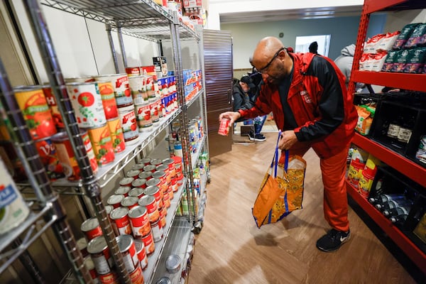 Wallace Goodson is seen selecting canned soups at the Shrine Community Market, which he has attended on and off since the 80s’; Goodson typically assists the church once every two weeks and volunteers for different programs.
Miguel Martinez /miguel.martinezjimenez@ajc.com