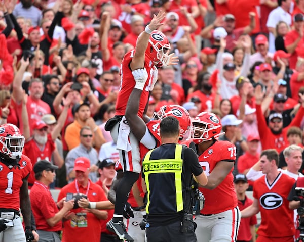 Georgia's quarterback Stetson Bennett (13) is lifted by teammates after scoring a touchdown against Tennessee at Sanford Stadium in Athens on Nov. 5, 2022. (Hyosub Shin / Hyosub.Shin@ajc.com)