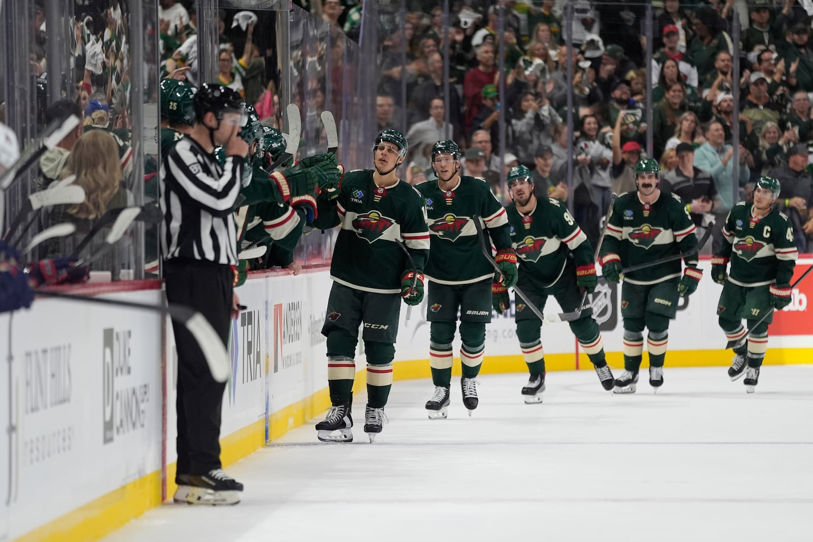 Minnesota Wild center Joel Eriksson Ek, front, celebrates with teammates after scoring during the second period of an NHL hockey game against the Columbus Blue Jackets, Thursday, Oct. 10, 2024, in St. Paul, Minn. (AP Photo/Abbie Parr)