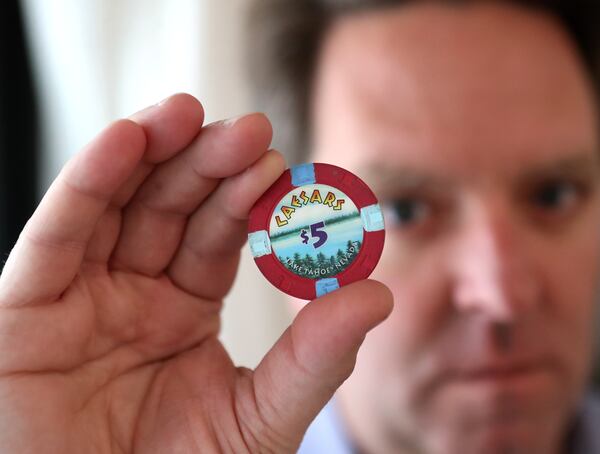 Matt Paxton, a former expert on “Hoarders” shows off a Caesar’s chip, one of his personal legacy items. Curtis Compton / Curtis.Compton@ajc.com