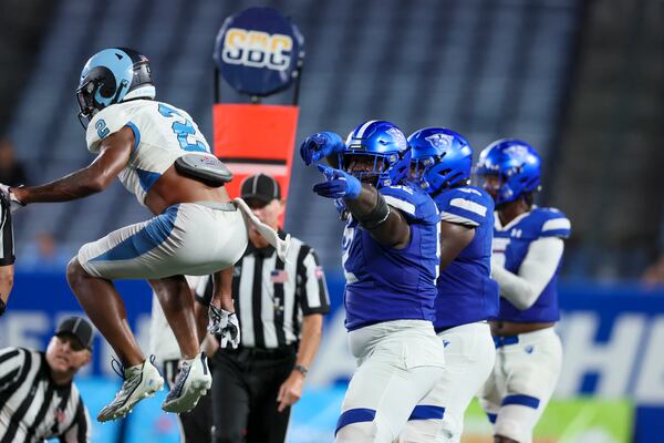 Georgia State offensive tackle Travis Glover (52) celebrates a first down after Georgia State running back Marcus Carroll (not pictured) converted a 4th and 1 to secure their win during the second half against Rhode Island at Center Parc Stadium, Thursday, August 31, 2023, in Atlanta. Georgia State won 42-35. (Jason Getz / Jason.Getz@ajc.com)