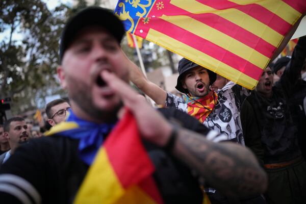 Demonstrators shout as they gather for a protest organized by social and civic groups, denouncing the handling of recent flooding under the slogan "Mazón, Resign," aimed at the president of the regional government Carlos Mazon, in Valencia, Spain, Saturday, Nov. 9, 2024. (AP Photo/Emilio Morenatti)