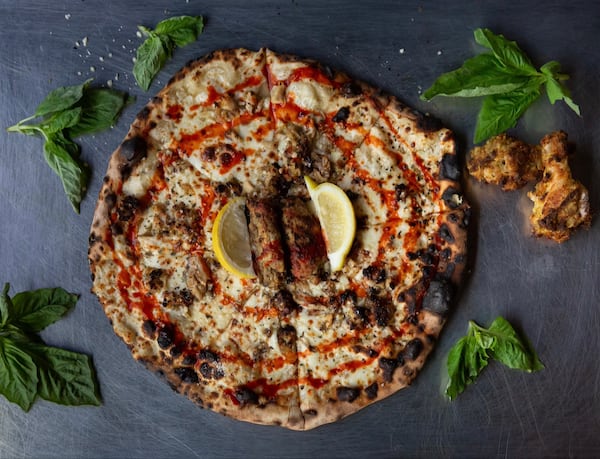 Atlanta native Matthew Foster wanted to create a pizza that pays tribute to local culture. His solution was to add lemon-pepper sauce and a couple of wet, lemon-pepper wing flats to a pizza. Courtesy of Drew Amandolia