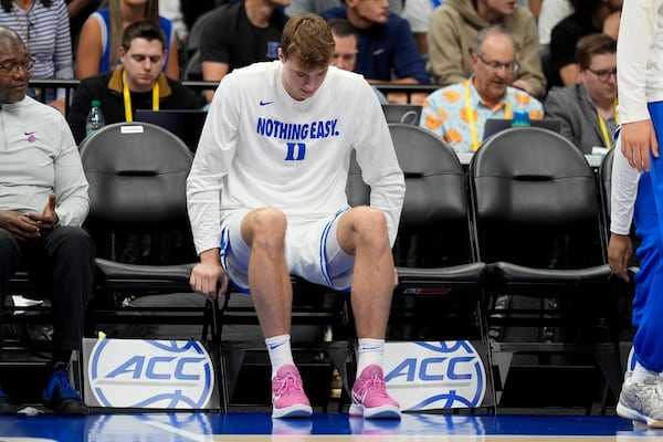 Duke forward Cooper Flagg sits on the bench during the second half of an NCAA college basketball game against Georgia Tech in the quarterfinals of the Atlantic Coast Conference tournament, Thursday, March 13, 2025, in Charlotte, N.C. Flagg was injured in the first half. (AP Photo/Chris Carlson)