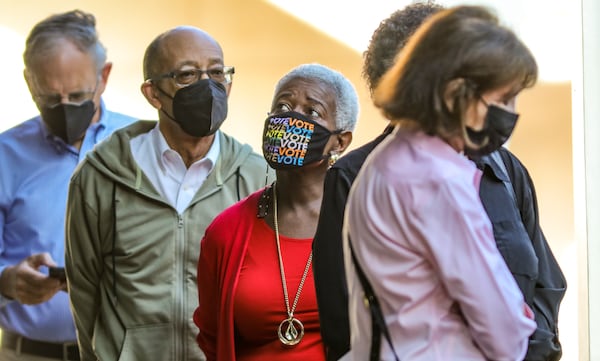 Josephine Reed-Taylor (center) waits with other voters who gathered at the Buckhead Library for early voting May 2. (John Spink / John.Spink@ajc.com)


