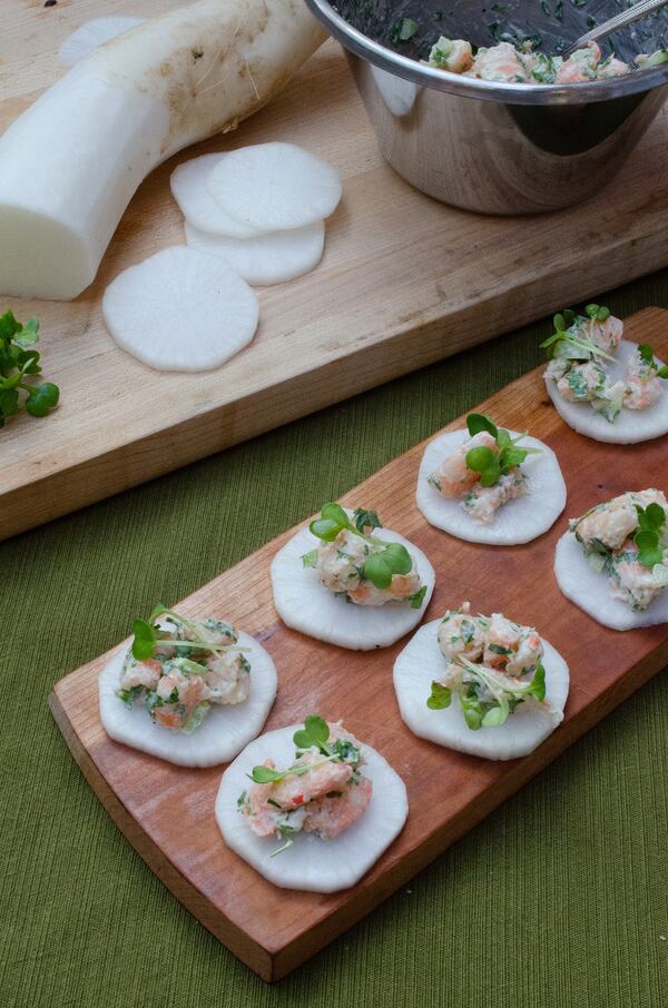 For Daikon “Crostini” with Shrimp Salad, crisp disks of sweet, sharp daikon are topped with shrimp salad. (Virginia Willis for The Atlanta Journal-Constitution)