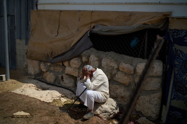 Muhammad Mughanem, sits in front of his house the day after a settler's attack in the village of Susiya in Masafer Yatta, south Hebron hills Tuesday, March 25, 2025. (AP Photo/Leo Correa)