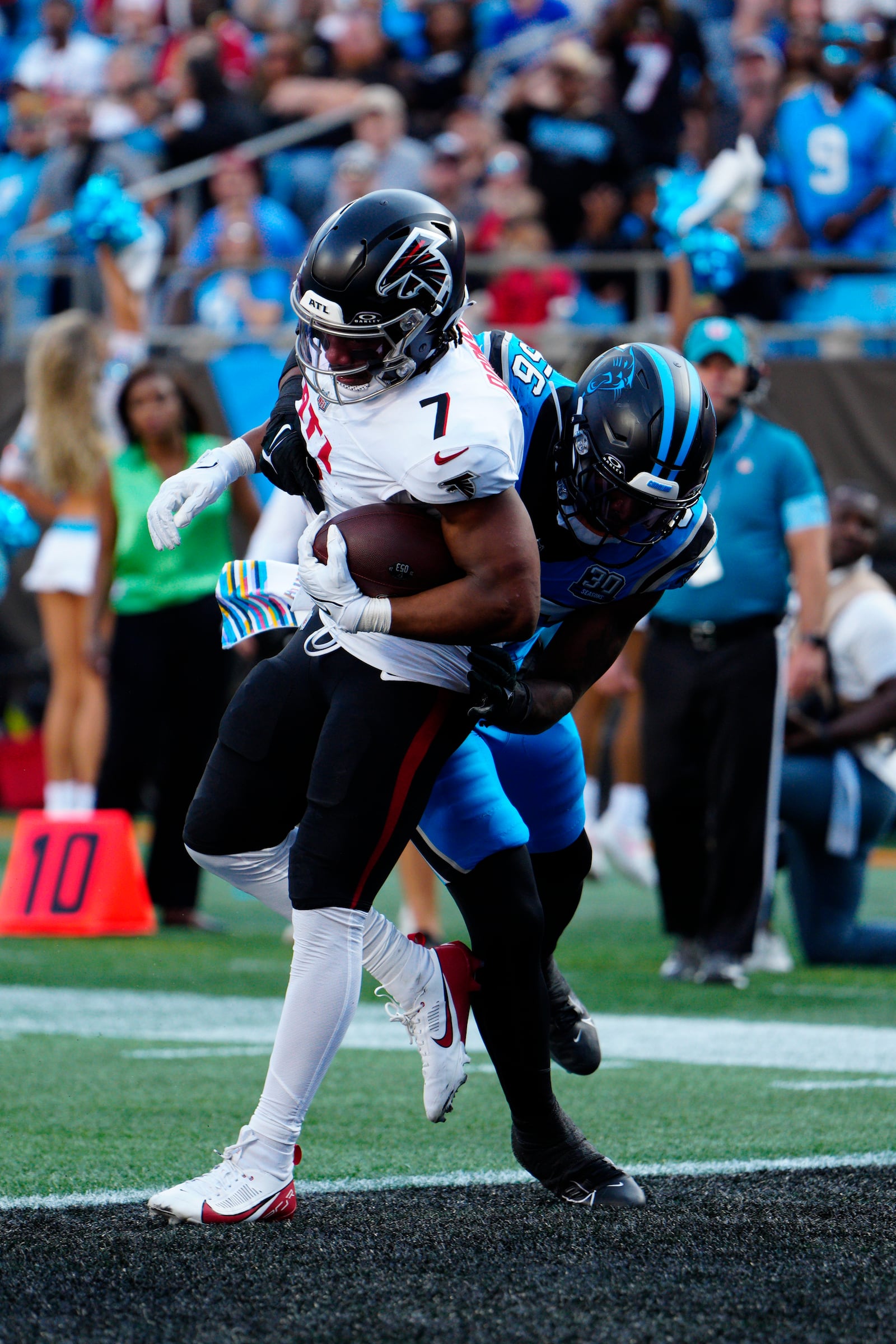 Atlanta Falcons running back Bijan Robinson (7) runs in a touchdown against Carolina Panthers linebacker Trevin Wallace (56) in the first half of an NFL football game against in Charlotte, N.C., Sunday, Oct. 13, 2024. (AP Photo/Jacob Kupferman)