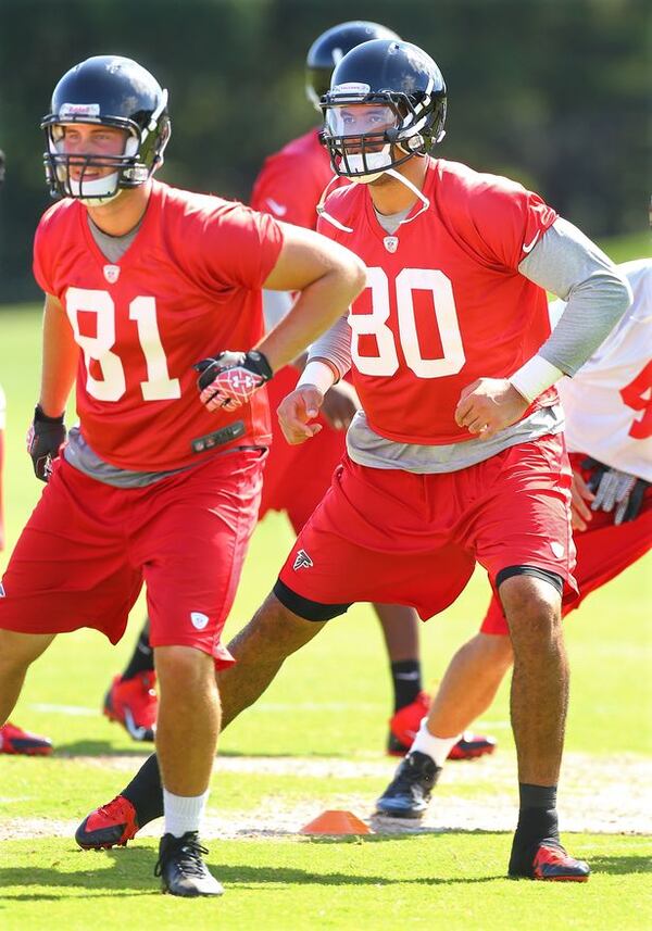 Falcons tight ends Jacob Pedersen (left) and Levine Toilolo (right) run drills during team practice on Tuesday, June 10, 2014, in Flowery Branch. (By Curtis Compton/CCompton@ajc.com)