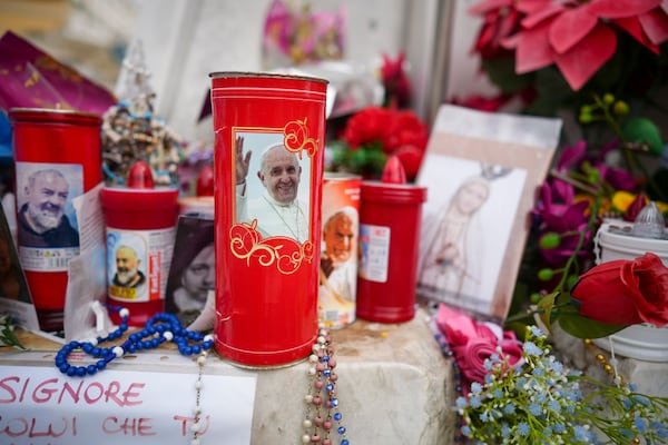 Candles and flowers are left for Pope Francis in front of the Agostino Gemelli Polyclinic, in Rome, Saturday, March 8, 2025, where the Pontiff is hospitalized since Feb. 14. (AP Photo/Andrew Medichini)