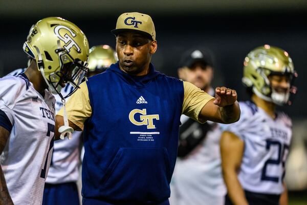 Georgia Tech secondary coach Travares Tillman speaks with Yellow Jackets cornerback Zamari Walton during spring practice in February 2022. (Danny Karnik/Georgia Tech Athletics)