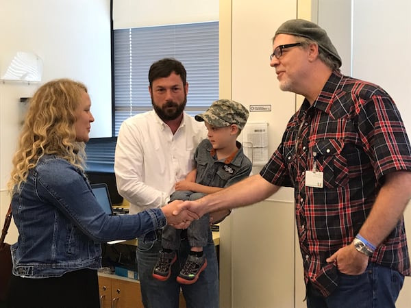 Eric Von Haessler greeting Lisa Ryker and her husband Lowe. Their four-year-old son Harlan is being treated at AFLAC Cancer Center for leukeumia.