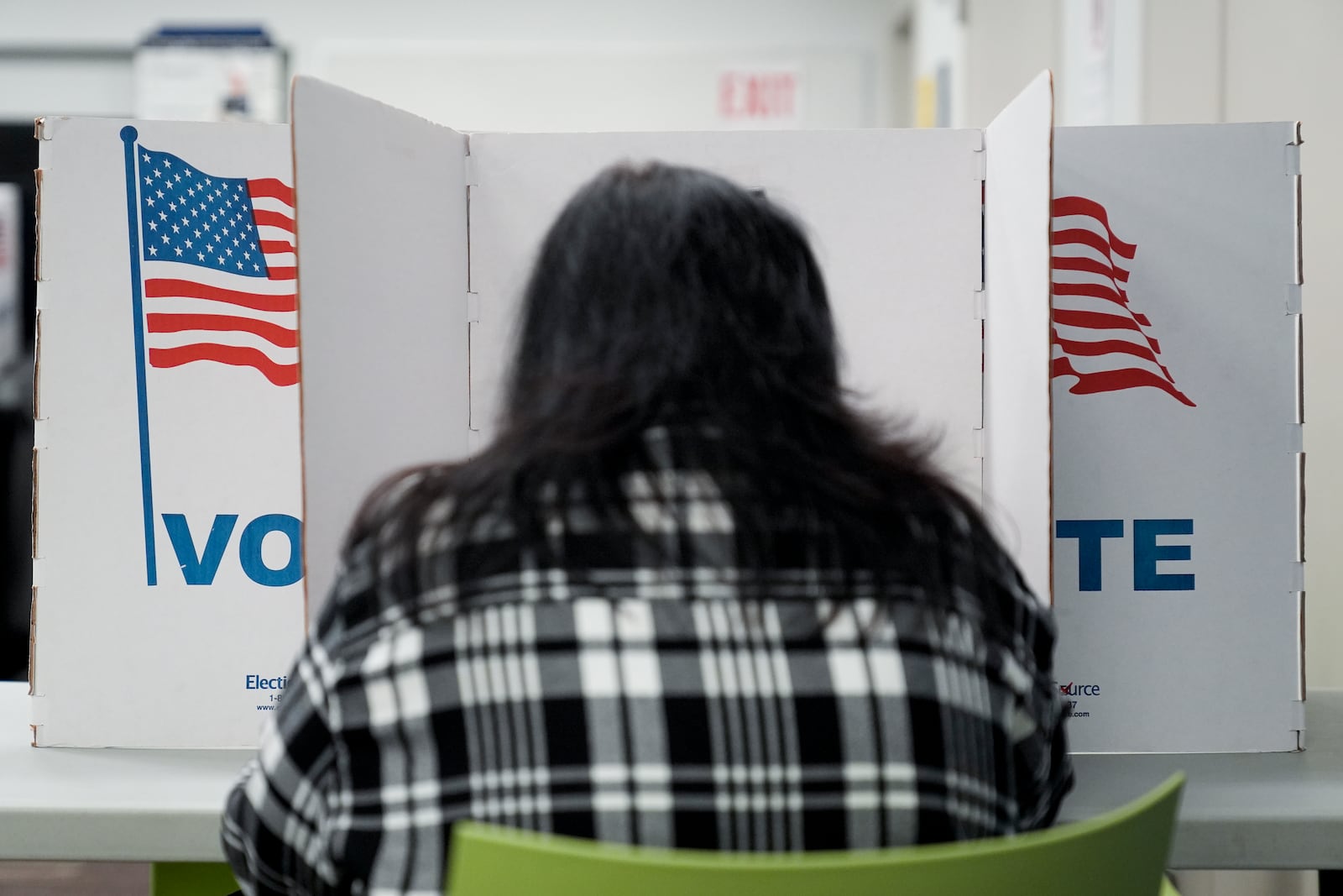 A person marks their ballot at the polling place at Tysons-Pimmit Regional Library in Falls Church, Va., Thursday, Oct. 31, 2024. (AP Photo/Stephanie Scarbrough)