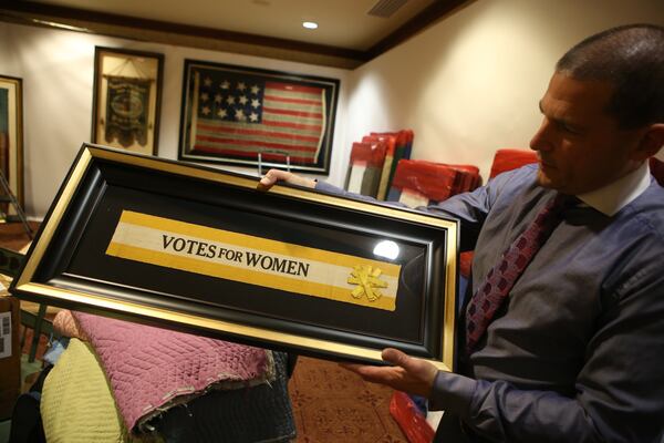 At the 2017 Cathedral Antiques Show in Atlanta, Jeff Bridgman shows off a piece of a sash that had been worn during the women’s suffrage movement in the early 20th century. Bridgman, owner of Jeff R. Bridgman Antiques Inc., is the nation’s largest collector and dealer of antique American flags, and he’s at this week’s show. HENRY TAYLOR / HENRY.TAYLOR@AJC.COM