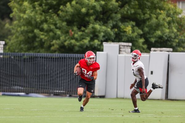 Georgia wide receiver Ladd McConkey (84) evades defensive back Kamari Lassiter (3) during the Bulldogs’ practice Tuesday, Aug. 31, 2021, in Athens. (Mackenzie Miles/UGA)