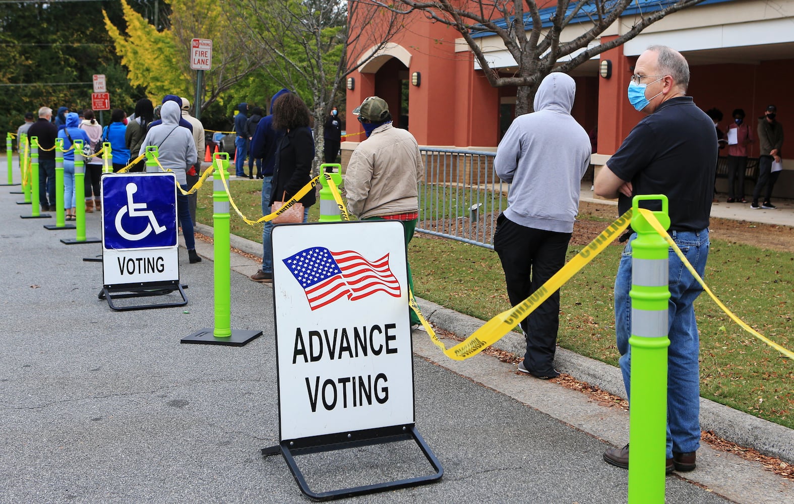 People wait in line for early voting on Friday, October 30, 2020, at the Cobb County Tax Commissioner Office on Whitlock Avenue in Marietta, Georgia. The estimated wait time was over 90 minutes at around 9:20 a.m. at the polling location. CHRISTINA MATACOTTA FOR THE ATLANTA JOURNAL-CONSTITUTION.