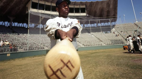 Braves outfielder Hank Aaron takes a swing of hist bat at Atlanta Stadium, circa 1969.