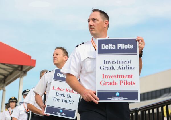 June 24, 2016 Atlanta: Delta pilots conduct informational picketing at the south terminal at Hartsfield-Jackson Atlanta International Airport on Friday morning. Delta pilots are raising awareness and urgency with Delta management for higher pay in negotiations for a new labor contract. "We are almost six months overdue for a new labor contract," said Master Executive Council (MEC) Chairman of Delta Airlines, John Malone, who has worked at Delta Airlines for 28 years. Delta pilots around the country also participated on Friday morning. EMILY JENKINS/ EJENKINS@AJC.COM