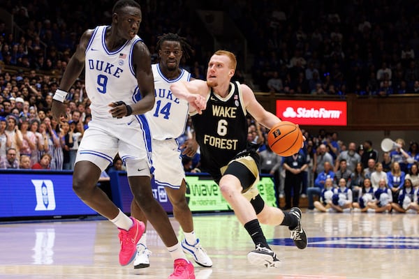 Wake Forest's Cameron Hildreth (6) drives past Duke's Khaman Maluach (9) and Sion James (14) during the first half of an NCAA college basketball game in Durham, N.C., Monday, March 3, 2025. (AP Photo/Ben McKeown)