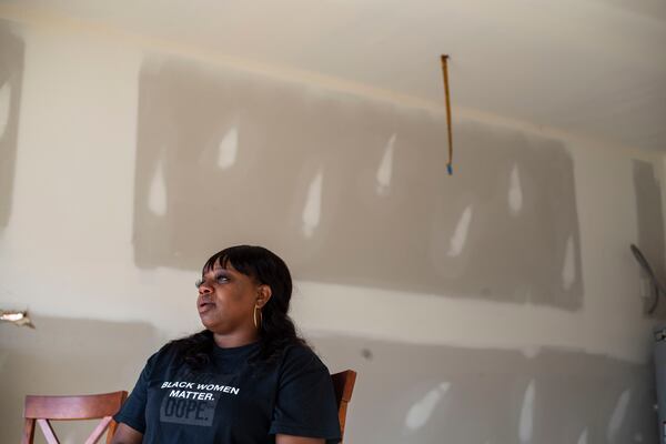 Brittany Mitchell becomes emotional as she recounts her experience riding out the tornado at her residence in Newnan. (Alyssa Pointer / Alyssa.Pointer@ajc.com)