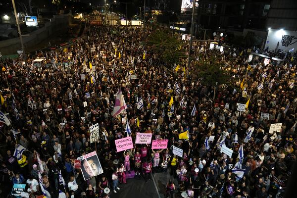 People gather to protest against Prime Minister Benjamin Netanyahu's government and call for the release of hostages held in the Gaza Strip by the Hamas militant group, in Tel Aviv, Israel, Saturday, Nov. 23, 2024. (AP Photo/Maya Alleruzzo)