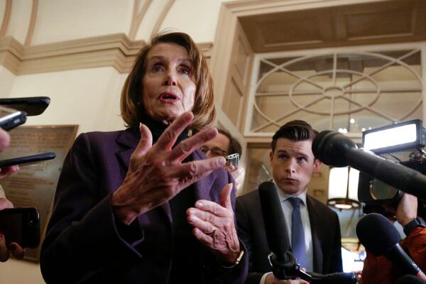 Speaker of the House Nancy Pelosi, D-Calif., takes questions from reporters as she arrives at the Capitol, the morning after President Donald Trump used his executive power to deny military aircraft to her and other members of Congress for a secret visit to troops abroad, in Washington, Friday, Jan. 18, 2019. Pelosi canceled her plans today to travel by commercial plane to visit U.S. troops in Afghanistan, saying President Donald Trump had caused a security risk by talking about the trip. (AP Photo/J. Scott Applewhite)